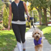 Woman walking dog in black weighted vest from Power WearHouse